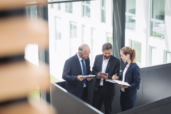 Law team talking with devices in hand